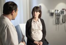 pregnant woman talking to her doctor