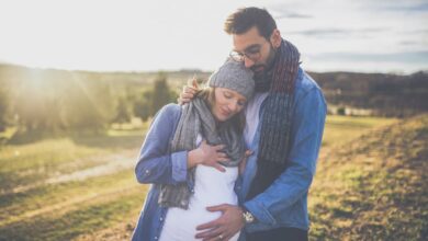 man touching her pregnant partner