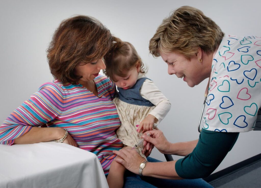 nurse giving a treatment her baby
