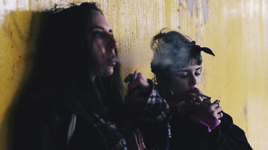 2 girls smoking in public